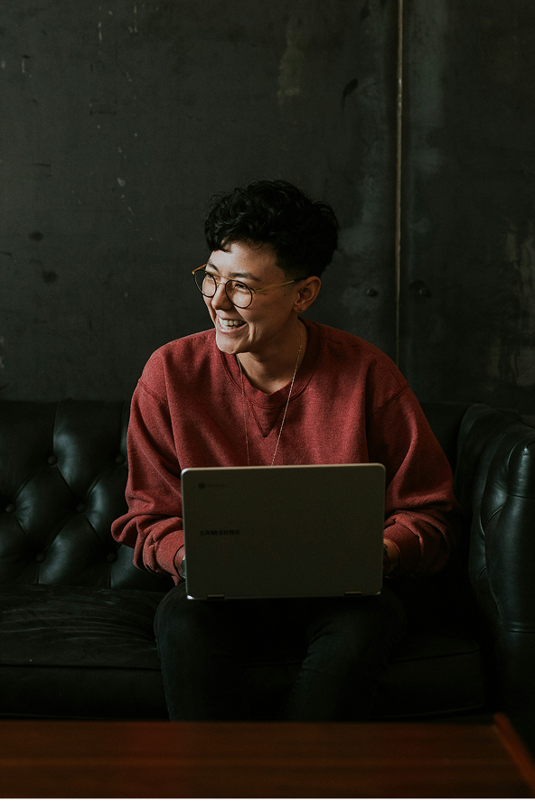 Woman smiling using computer
